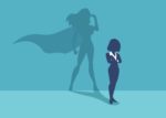Silhouetted Business Woman with a Superhero Shadow