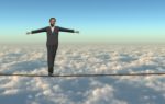 Businessman on a tight rope in the sky