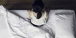 Woman sitting on a bed Woman sitting on a bed